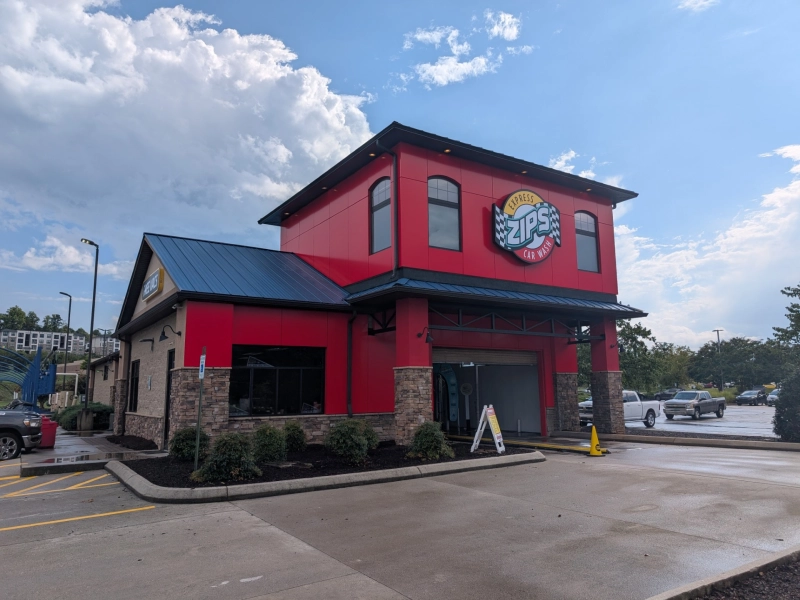 Outside of newly refreshed Moss Grove ZIPS Car Wash location with a bright, shining red exterior