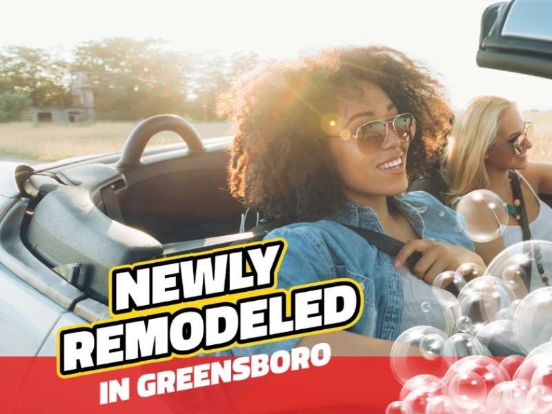 Two women driving in a clean convertible with text that reads "Newly Remodeled in Greensboro"