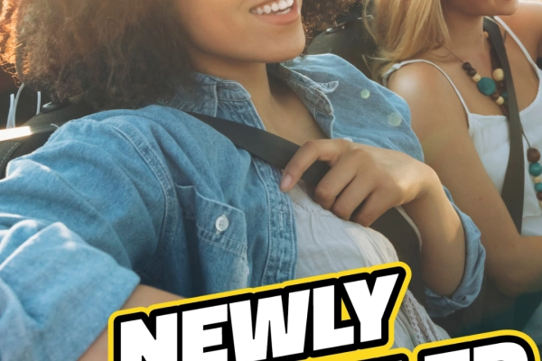 Two women smiling driving a clean car with bubbles. Text reads: "Newly Remodeled in Myrtle Beach"